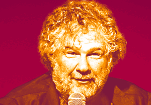 a man with curly hair holding a microphone