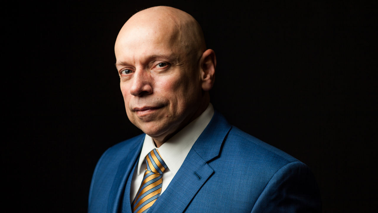 Retrato profissional de homem careca em terno azul