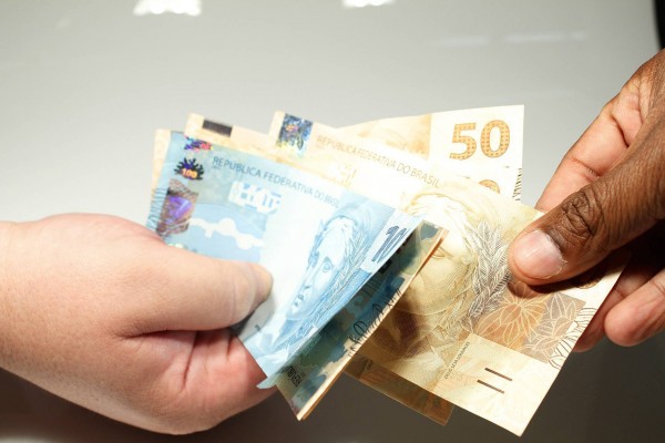 Troca de Dinheiro: Notas de Real em Mãos.