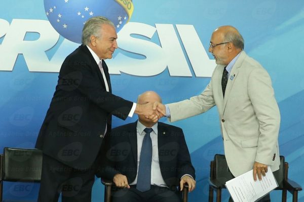 Michel Temer e autoridade selando acordo em evento oficial