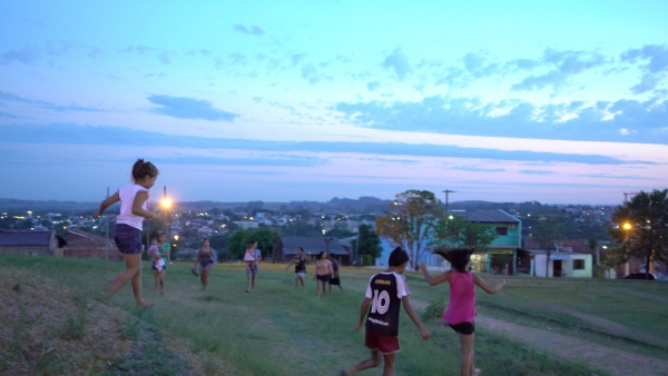 Crianças Brincando ao Entardecer na Periferia Urbana