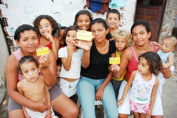 Famílias em comunidade carente celebram benefício do Bolsa Família.