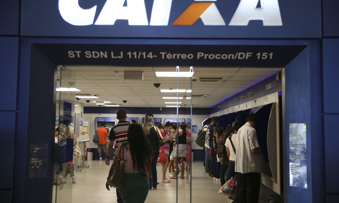 Pessoas em Fila de Autoatendimento da Caixa Econômica Federal