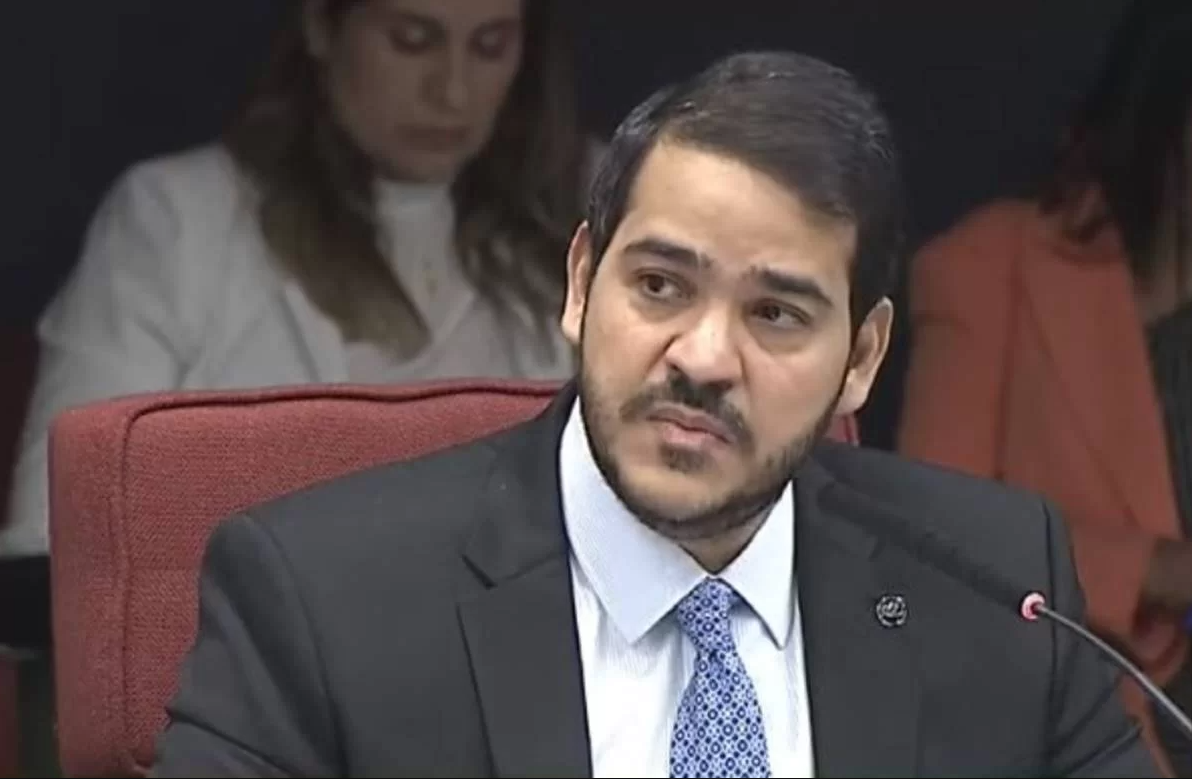 Homem em terno discursando em conferência