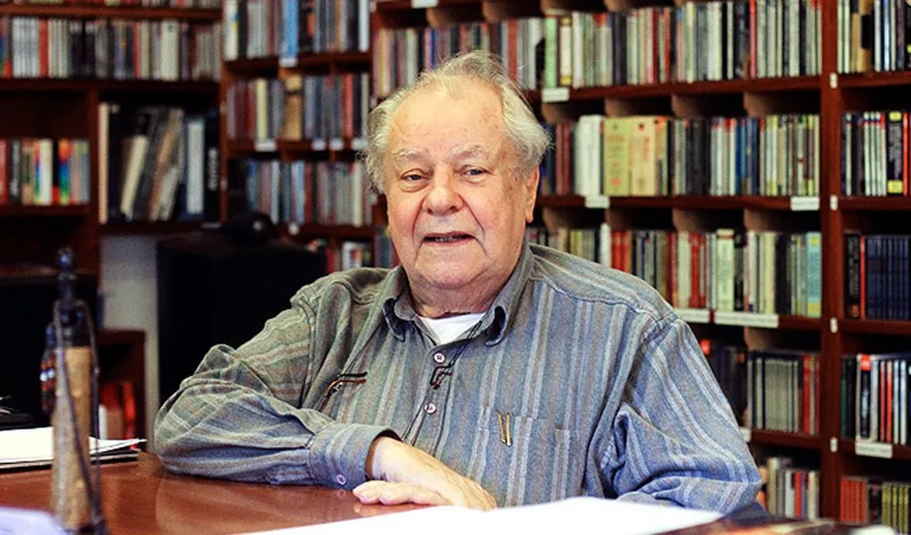 Homem Sábio em Biblioteca: Cultura e Conhecimento