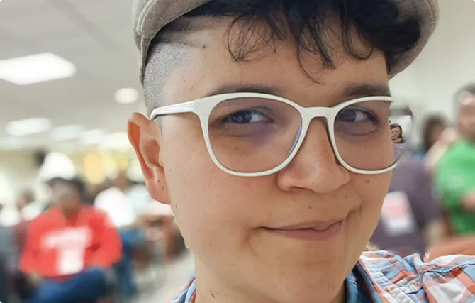 Jovem Sorridente com Óculos e Boné em Evento FPA